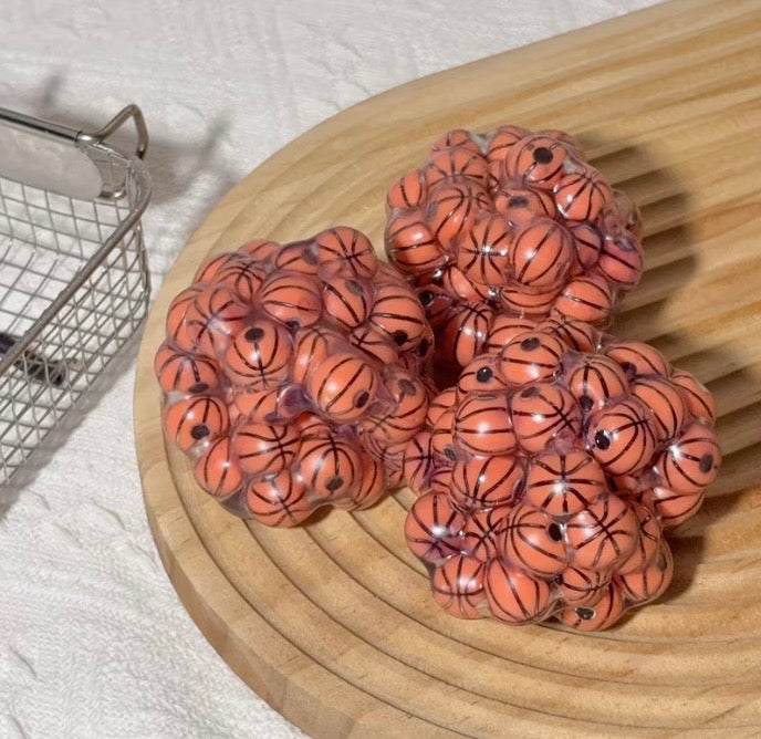 Basketball squishy fidget toy on a wooden board
