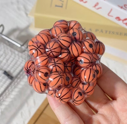 Basketball squishy fidget toy held in hand